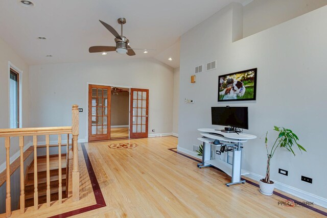 living area featuring french doors, visible vents, baseboards, and wood finished floors