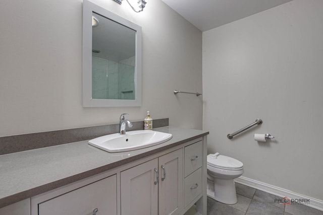 bathroom featuring baseboards, toilet, tile patterned floors, walk in shower, and vanity