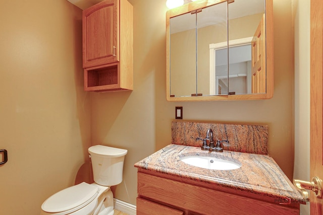 bathroom with toilet, tasteful backsplash, and vanity