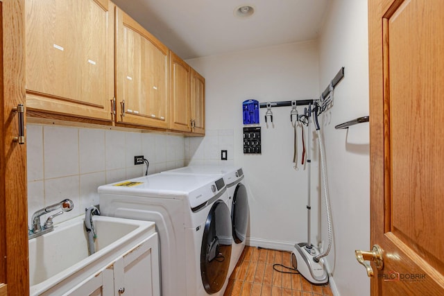 laundry area featuring tile walls, light tile patterned floors, cabinet space, a sink, and independent washer and dryer