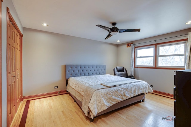 bedroom with light wood finished floors, baseboards, a closet, and recessed lighting