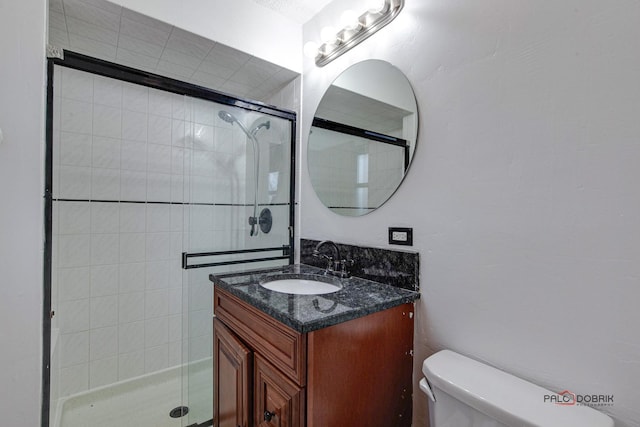 full bath with toilet, a stall shower, and vanity