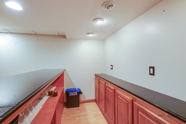 bar with light wood-style flooring