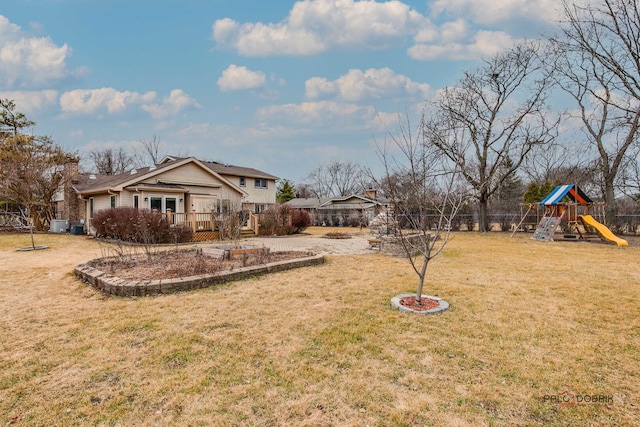 view of yard featuring fence and a playground