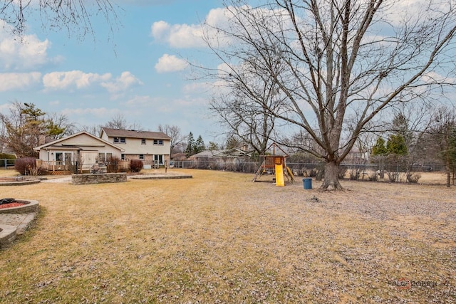 view of yard featuring a playground, a patio, and a fenced backyard