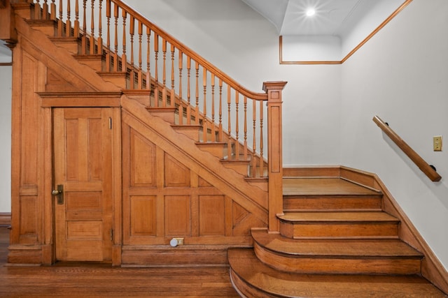 stairs featuring wood finished floors