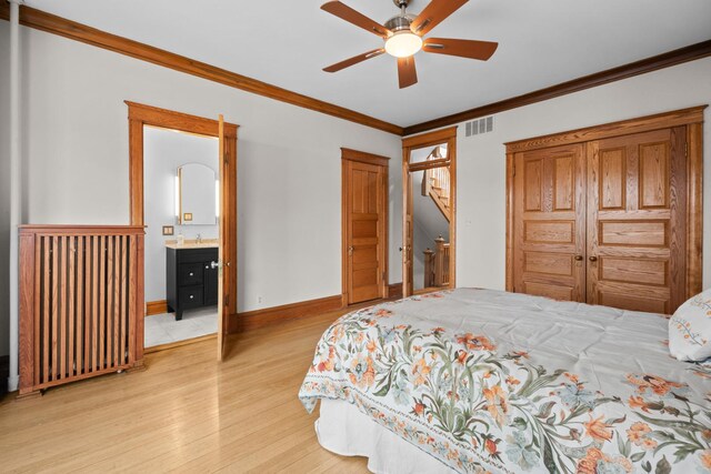 bedroom featuring baseboards, visible vents, ceiling fan, ornamental molding, and light wood-type flooring