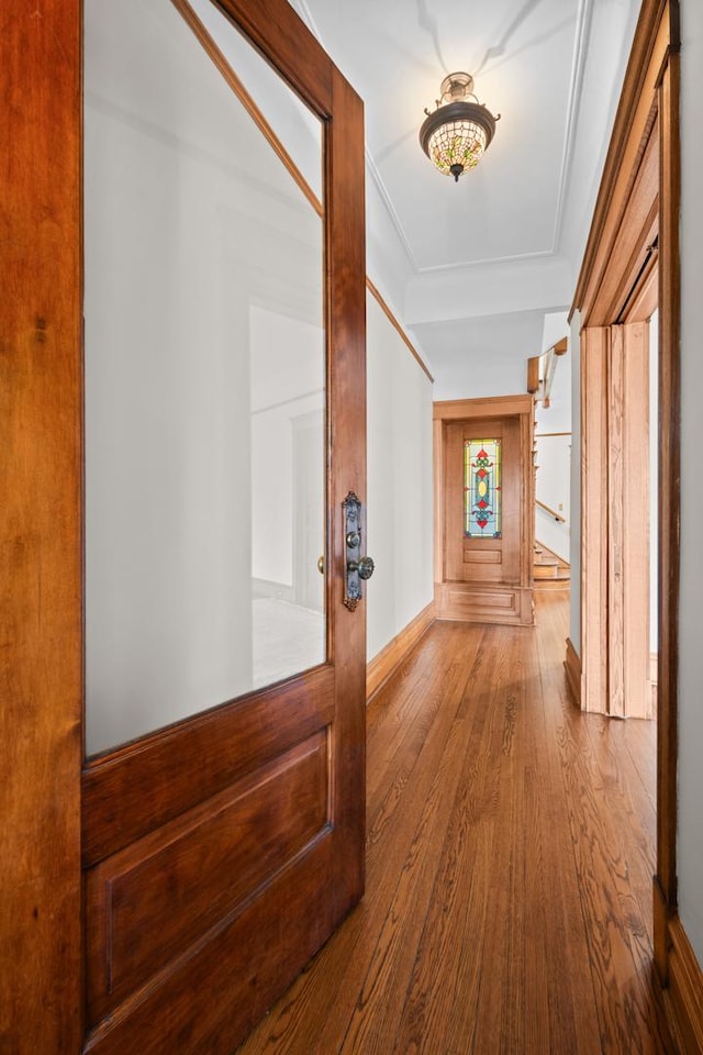 hallway featuring crown molding and wood finished floors