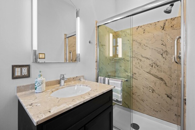 full bath with a shower stall and vanity