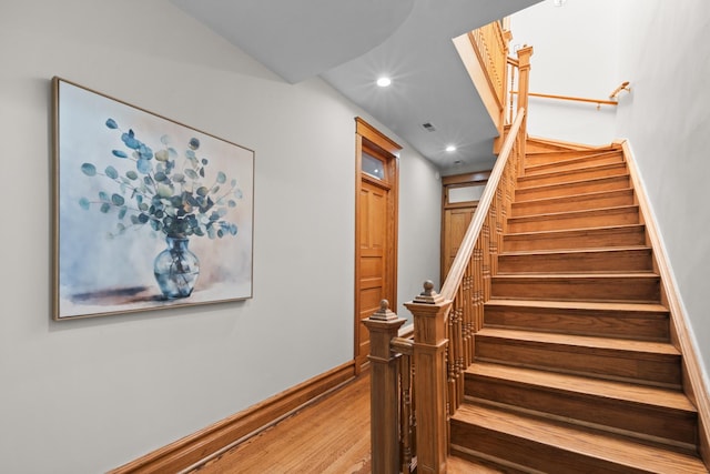 stairs with recessed lighting, baseboards, and wood finished floors