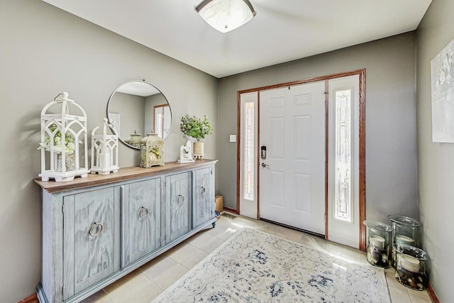 foyer featuring light tile patterned floors and baseboards