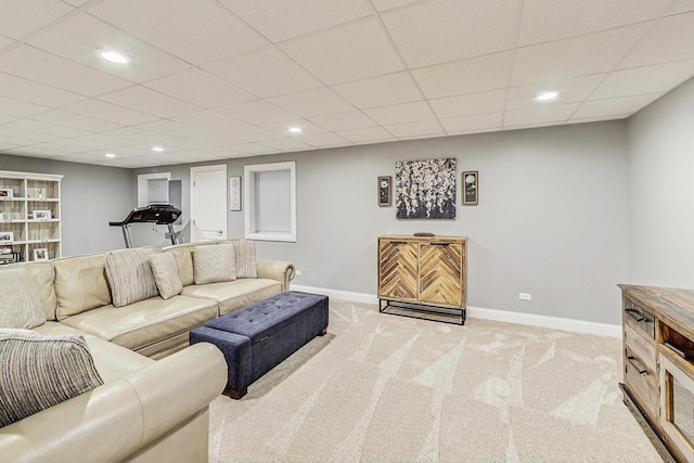 carpeted living room featuring recessed lighting, baseboards, and a drop ceiling