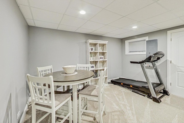 carpeted dining area featuring a drop ceiling, recessed lighting, and baseboards