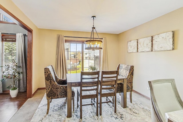 dining room with light tile patterned flooring and baseboards