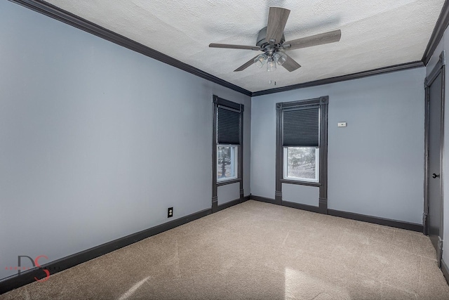 empty room featuring baseboards, ornamental molding, a textured ceiling, and light colored carpet