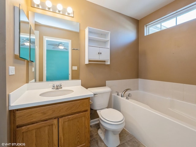 full bathroom featuring tile patterned floors, a garden tub, toilet, a ceiling fan, and vanity