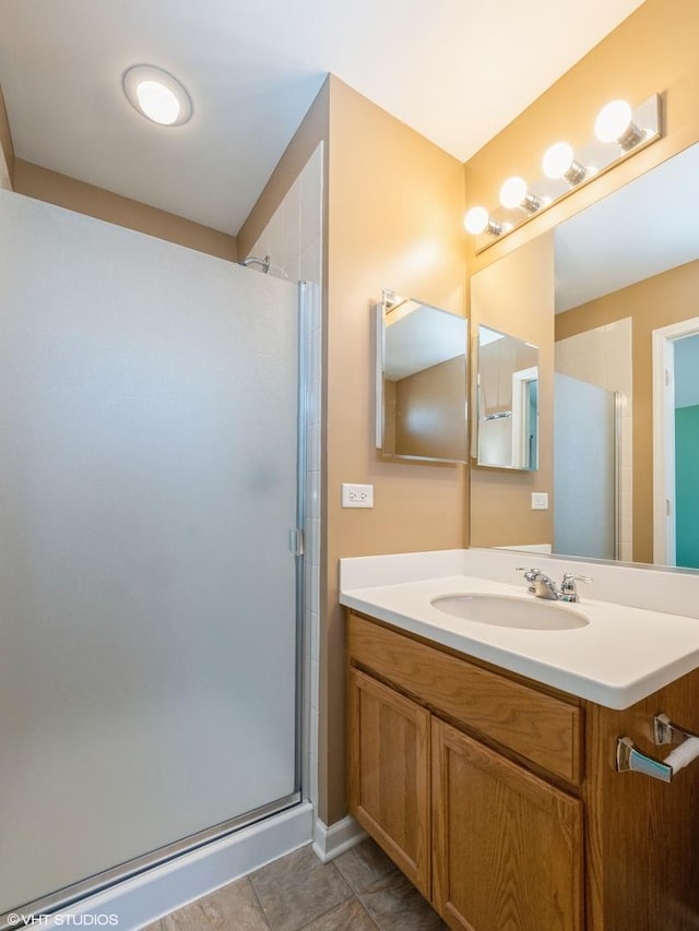 full bathroom featuring vanity, a shower stall, and tile patterned flooring