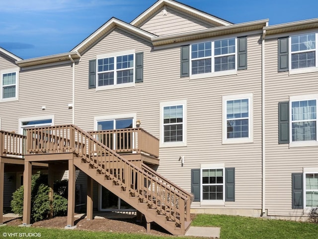 back of house with stairs and a deck