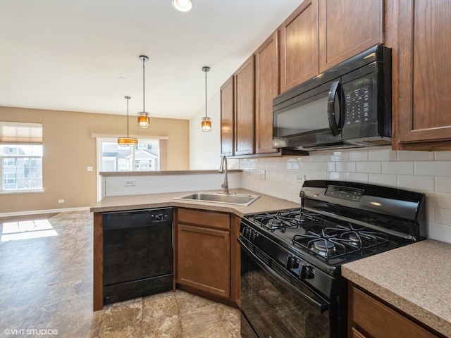 kitchen with black appliances, a sink, a peninsula, decorative backsplash, and hanging light fixtures