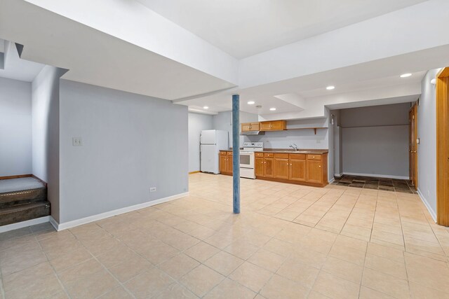 interior space featuring a sink, under cabinet range hood, recessed lighting, white appliances, and baseboards