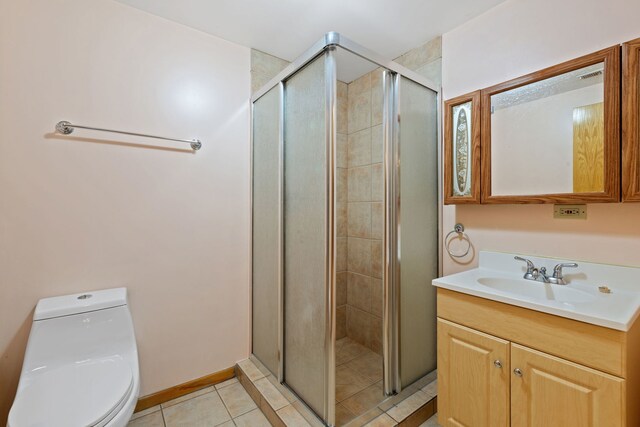 full bathroom with baseboards, toilet, a stall shower, tile patterned floors, and vanity