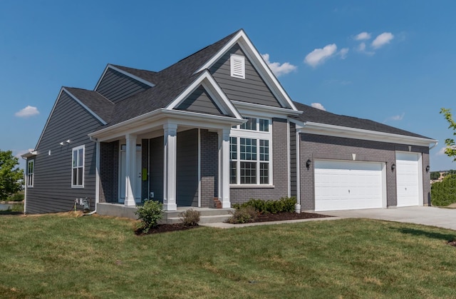 view of front of house with an attached garage, a front yard, concrete driveway, and brick siding