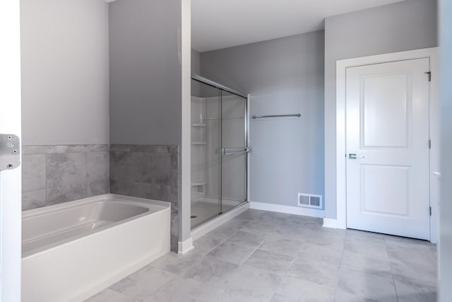 full bathroom featuring a stall shower, visible vents, a garden tub, and baseboards