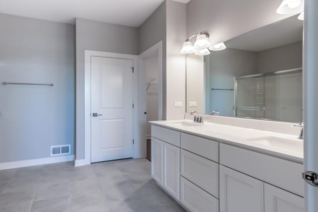 full bathroom featuring a stall shower, visible vents, a sink, and double vanity