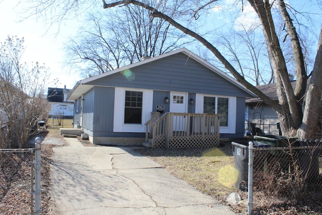 bungalow-style home featuring fence