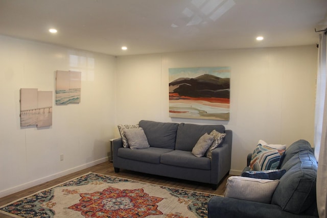 living area featuring baseboards, wood finished floors, and recessed lighting