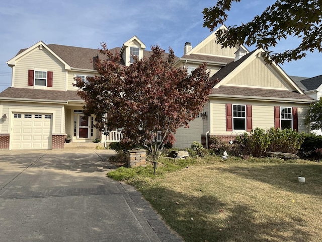 craftsman-style house with concrete driveway, brick siding, a front lawn, and a shingled roof