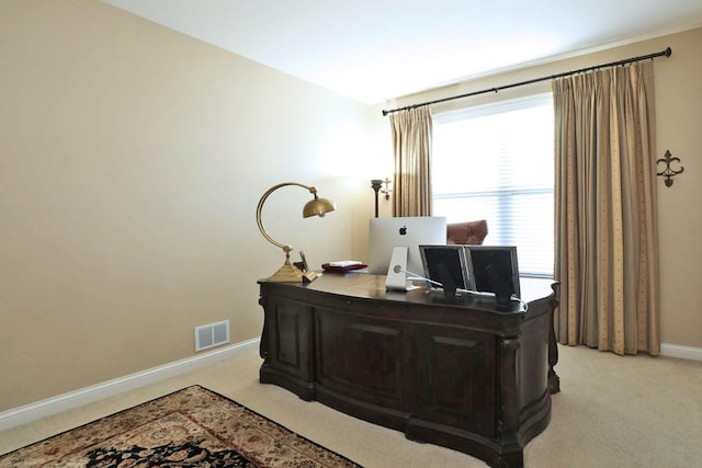 home office with light colored carpet, visible vents, and baseboards