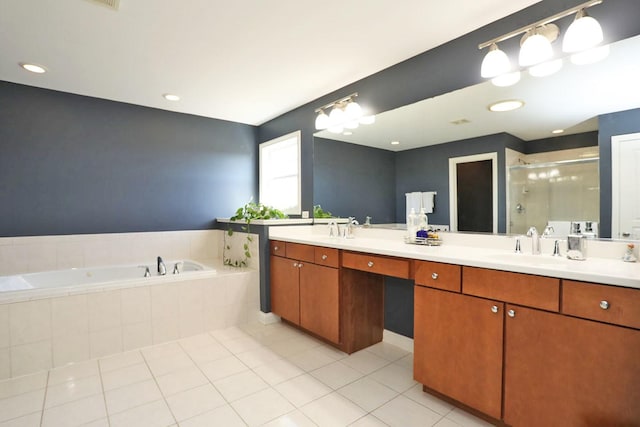 bathroom featuring a garden tub, double vanity, a stall shower, a sink, and tile patterned flooring