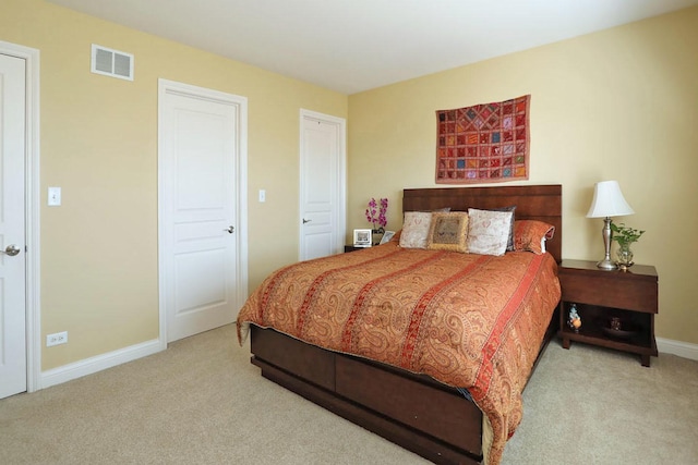 bedroom featuring baseboards, visible vents, and carpet flooring