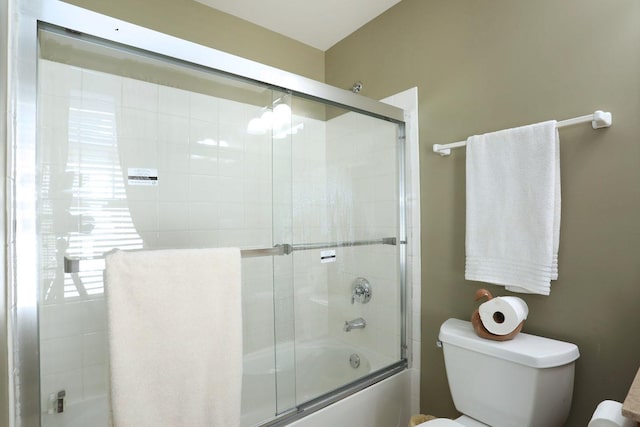 full bathroom featuring shower / bath combination with glass door and toilet