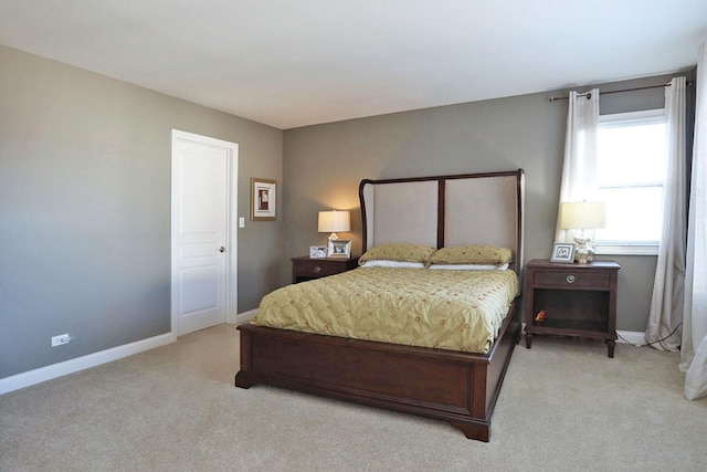 carpeted bedroom featuring baseboards