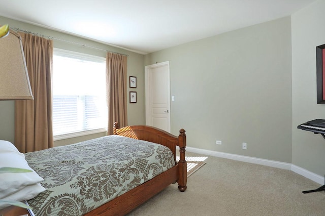 bedroom with carpet floors and baseboards