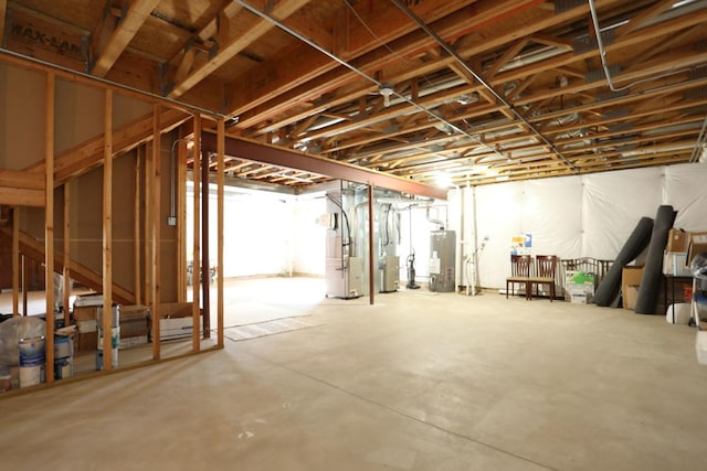 unfinished basement featuring heating unit and gas water heater