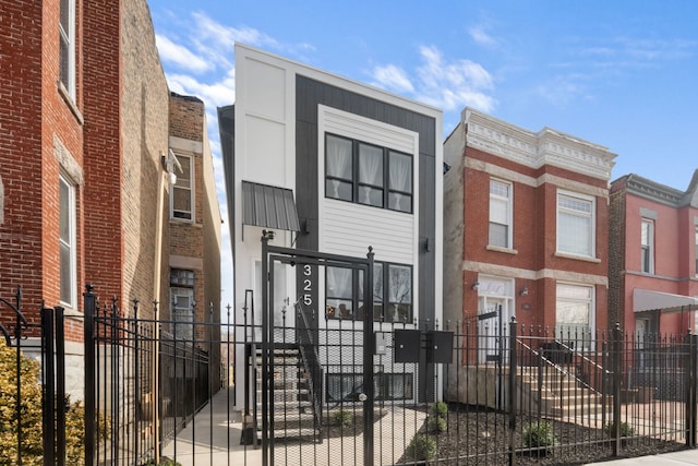 view of front of home featuring a fenced front yard and brick siding