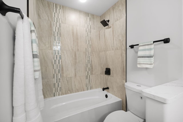 bathroom with bathing tub / shower combination and toilet