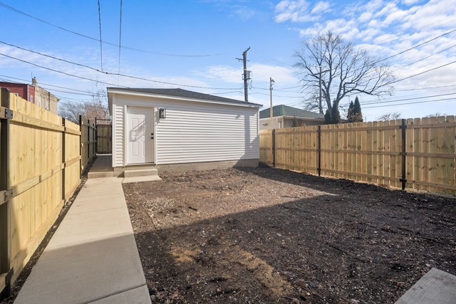 view of yard featuring a fenced backyard and an outdoor structure