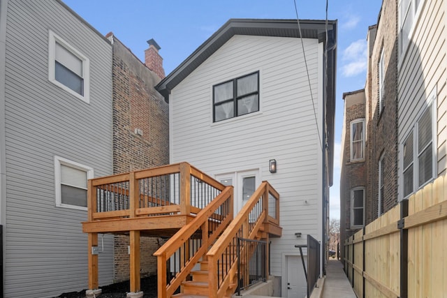 rear view of house featuring stairway and a wooden deck