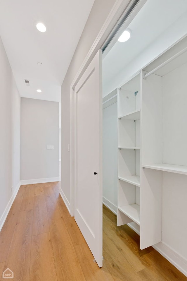 corridor featuring recessed lighting, light wood-type flooring, visible vents, and baseboards