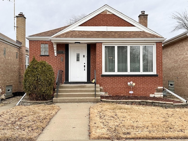 6155 S Melvina Ave, Chicago, IL 60638 - bungalow-style home featuring brick siding, a chimney, and a shingled roof