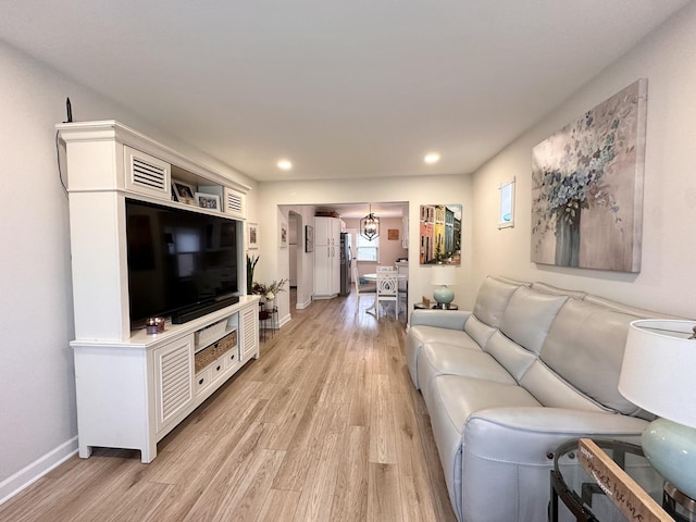 living room featuring light wood-type flooring, visible vents, baseboards, and recessed lighting