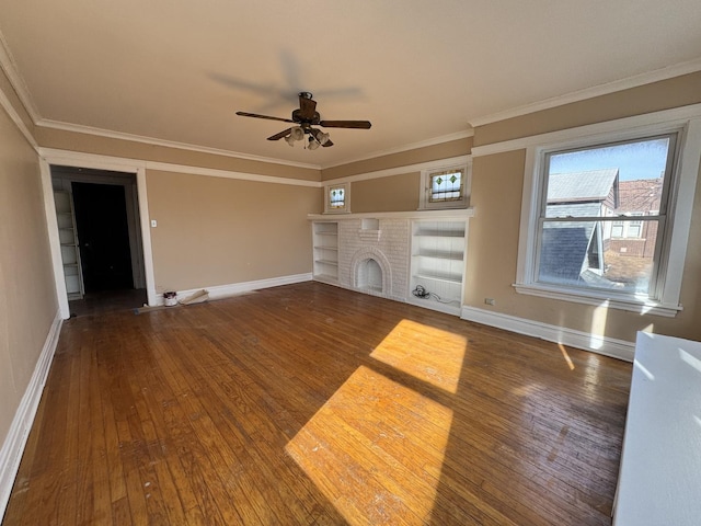 unfurnished living room featuring crown molding, wood-type flooring, a fireplace, and baseboards