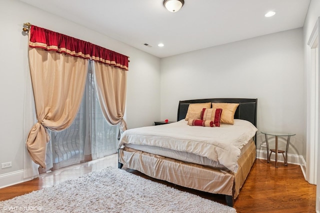 bedroom with recessed lighting, baseboards, and wood finished floors