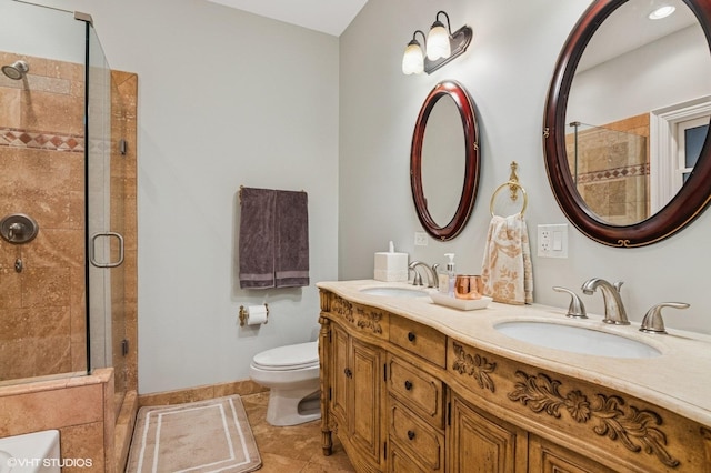 full bathroom with a sink, a shower stall, toilet, and double vanity