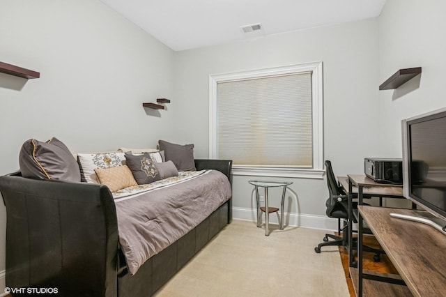 bedroom featuring baseboards and visible vents