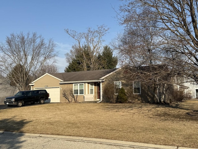 ranch-style home with a garage and a front yard